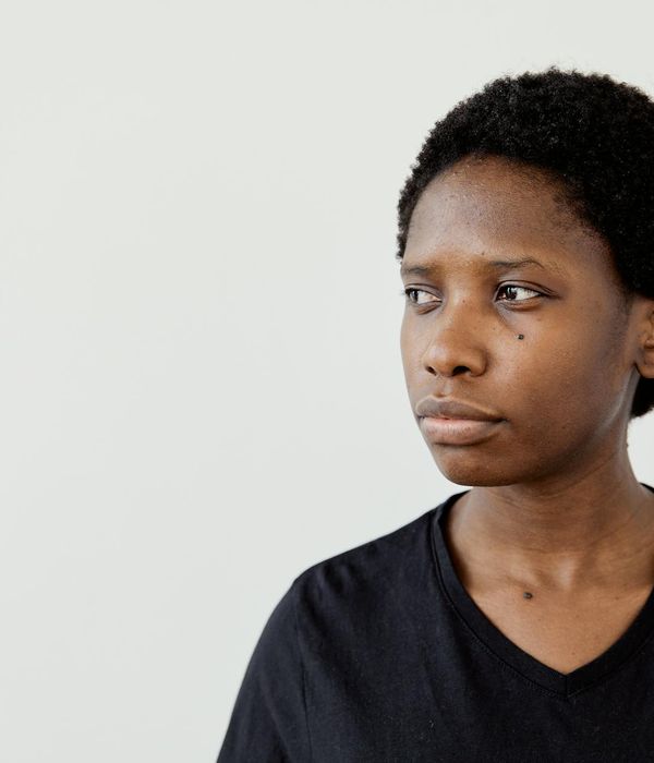 Woman with a calm expression looking into the distance, suggesting focus and clarity.